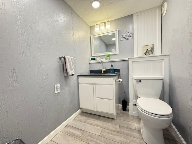 84 Williamson Rd, Hempfield Twp Mer, PA 16125 - bathroom with vanity, wood tiled floors, and a textured wall