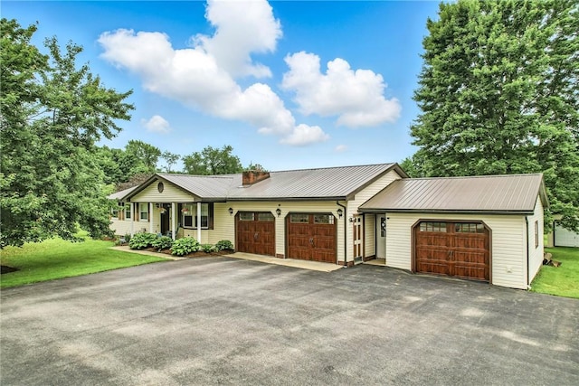 84 Williamson Rd, Hempfield Twp Mer, PA 16125 - ranch-style home with a garage, driveway, a front lawn, and a metal roof