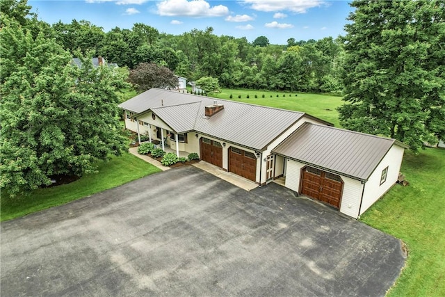84 Williamson Rd, Hempfield Twp Mer, PA 16125 - view of front of home with driveway, a front yard, an attached garage, a metal roof, and a porch
