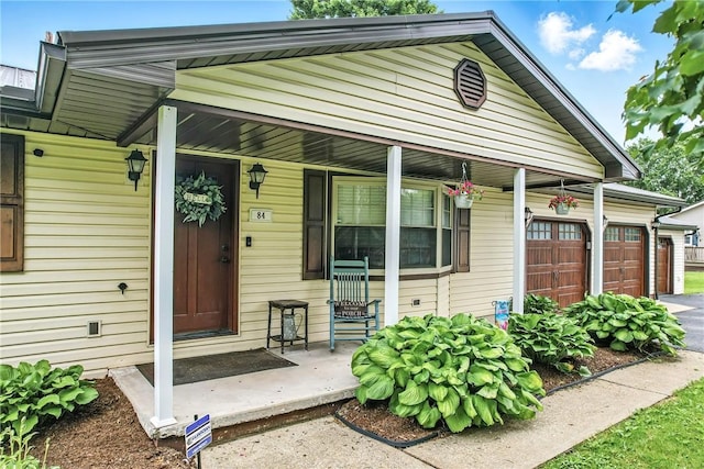 84 Williamson Rd, Hempfield Twp Mer, PA 16125 - doorway to property with a porch, a garage, and asphalt driveway