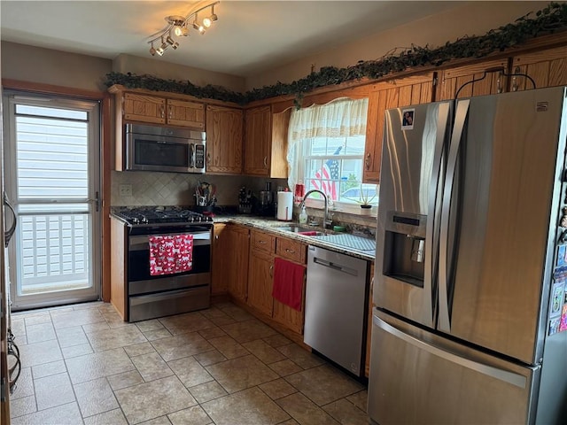 570 Hancock St, Cherryhll Twp/Clymer, PA 15728 - kitchen featuring appliances with stainless steel finishes, brown cabinets, backsplash, and light stone finish flooring