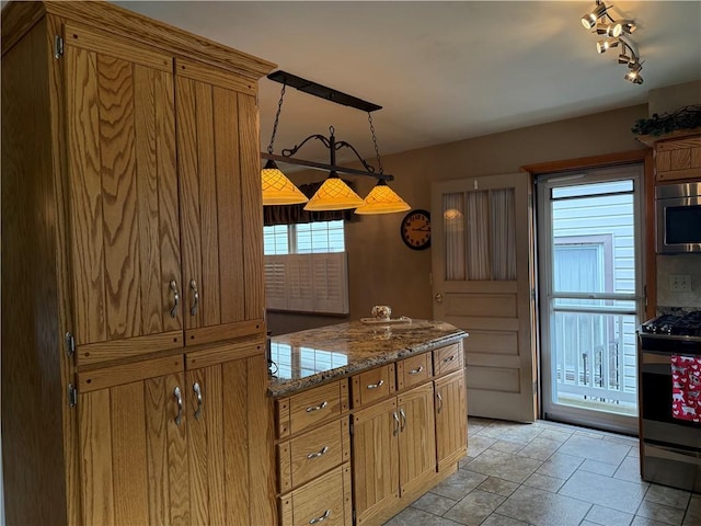 570 Hancock St, Cherryhll Twp/Clymer, PA 15728 - kitchen with appliances with stainless steel finishes, stone tile floors, brown cabinets, and decorative light fixtures