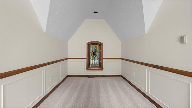 105 Bristol Sq, Ohara, PA 15238 - additional living space with lofted ceiling, wainscoting, a decorative wall, and light carpet