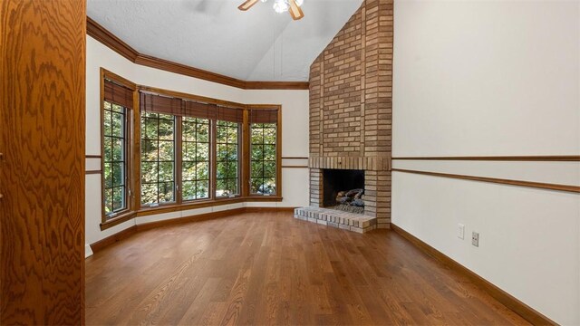 105 Bristol Sq, Ohara, PA 15238 - unfurnished living room featuring a ceiling fan, wood finished floors, a brick fireplace, high vaulted ceiling, and crown molding
