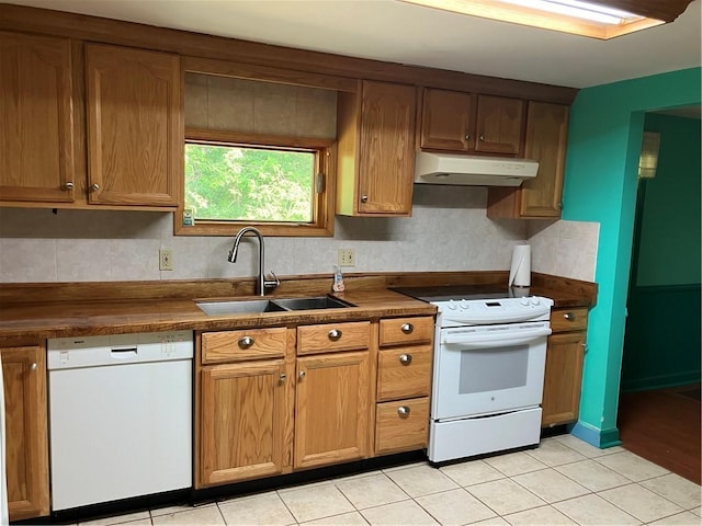 113 Filer Ln, Clay Twp, PA 16001 - kitchen featuring white appliances, exhaust hood, dark countertops, light tile patterned floors, and brown cabinets