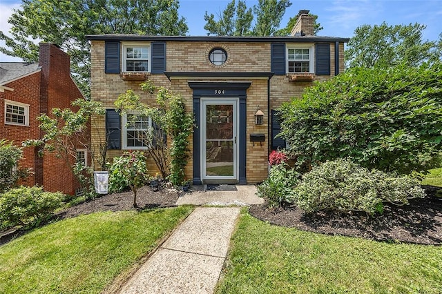 304 Fieldbrook Dr, Mt Lebanon, PA 15228 - view of front of house with brick siding, a chimney, and a front yard