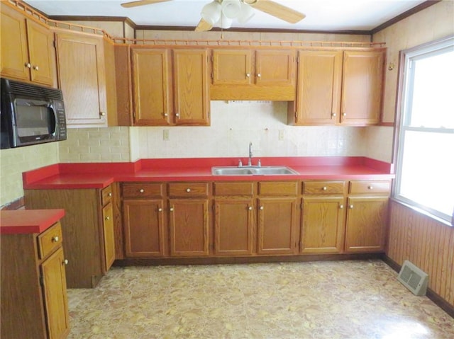 289 Sheridan Ln, Carmichaels/Cumblnd, PA 15351 - kitchen with black microwave, brown cabinets, a ceiling fan, backsplash, and light flooring