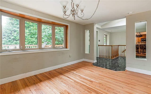 116 Parkfel Ave, Mccandless, PA 15237 - unfurnished room featuring a chandelier, plenty of natural light, wood finished floors, and a smoke detector