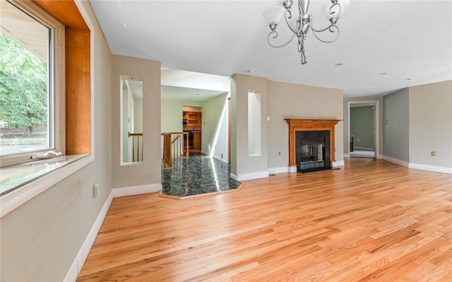 116 Parkfel Ave, Mccandless, PA 15237 - unfurnished living room featuring light wood-style flooring, a fireplace with flush hearth, and a chandelier