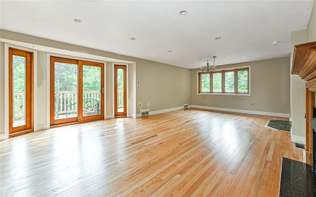 116 Parkfel Ave, Mccandless, PA 15237 - unfurnished living room with a fireplace with flush hearth, light wood-type flooring, and a chandelier