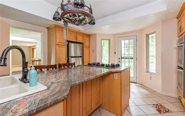 116 Parkfel Ave, Mccandless, PA 15237 - kitchen with stainless steel appliances, light tile patterned floors, dark stone counters, and a breakfast bar