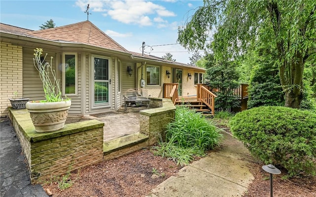 116 Parkfel Ave, Mccandless, PA 15237 - view of front of house with brick siding, a wooden deck, roof with shingles, and a patio area