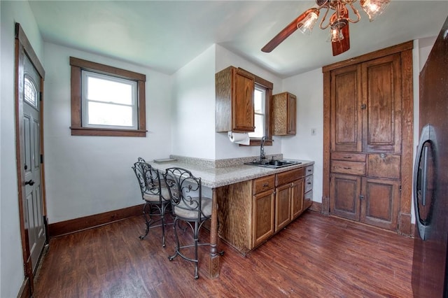 438 Miami St, East Mckeesport, PA 15035 - kitchen with brown cabinetry, a ceiling fan, and healthy amount of natural light