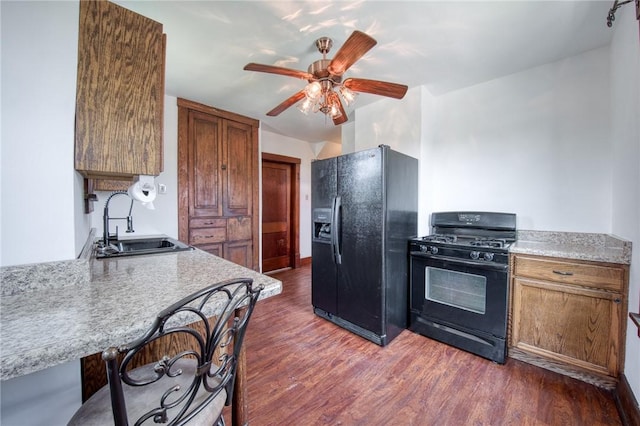 438 Miami St, East Mckeesport, PA 15035 - kitchen featuring black appliances, dark wood-style floors, a ceiling fan, and brown cabinetry