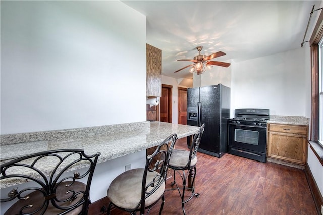 438 Miami St, East Mckeesport, PA 15035 - kitchen featuring black appliances, dark wood finished floors, brown cabinets, a breakfast bar, and ceiling fan