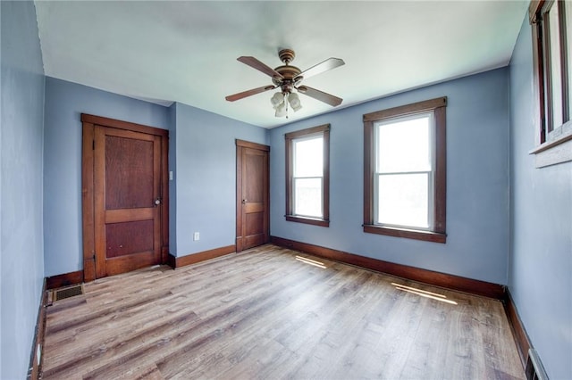 438 Miami St, East Mckeesport, PA 15035 - unfurnished bedroom with light wood-type flooring, a ceiling fan, and a closet