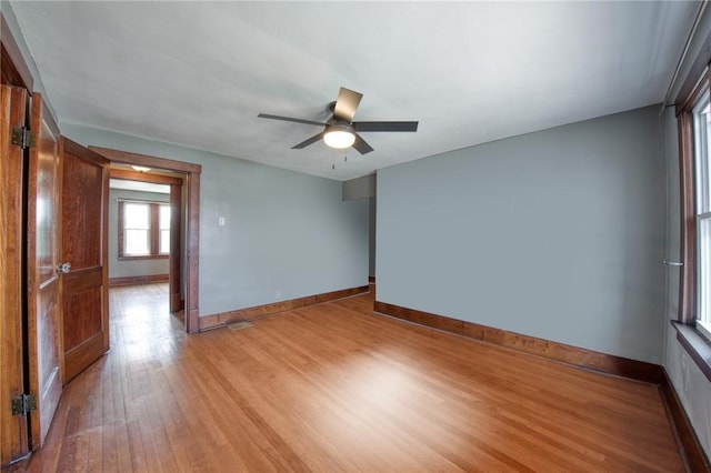 438 Miami St, East Mckeesport, PA 15035 - empty room with light wood finished floors and a ceiling fan