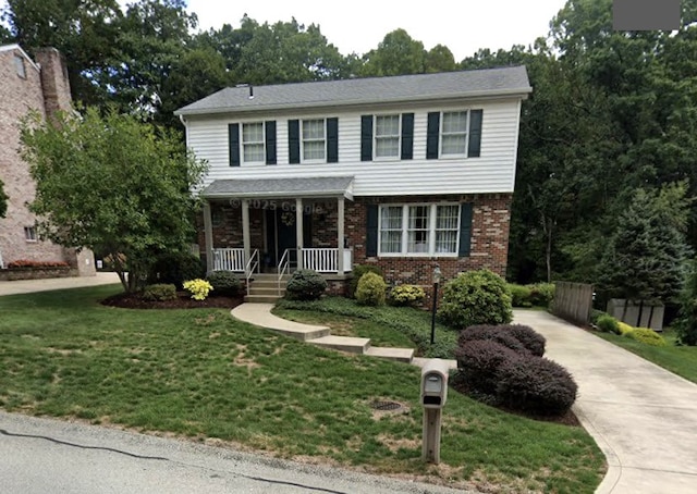 111 Brandywine Dr, Manor, PA 15642 - view of front of house featuring driveway, covered porch, and brick siding
