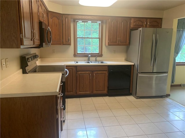 111 Brandywine Dr, Manor, PA 15642 - kitchen with stainless steel appliances, light countertops, and light tile patterned flooring