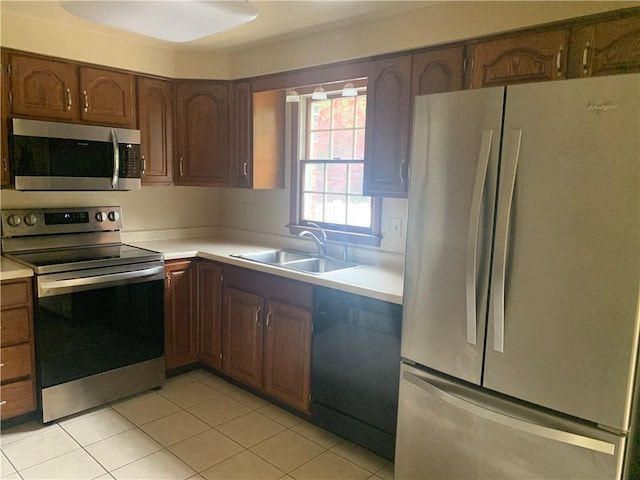 111 Brandywine Dr, Manor, PA 15642 - kitchen with appliances with stainless steel finishes, light countertops, and light tile patterned floors