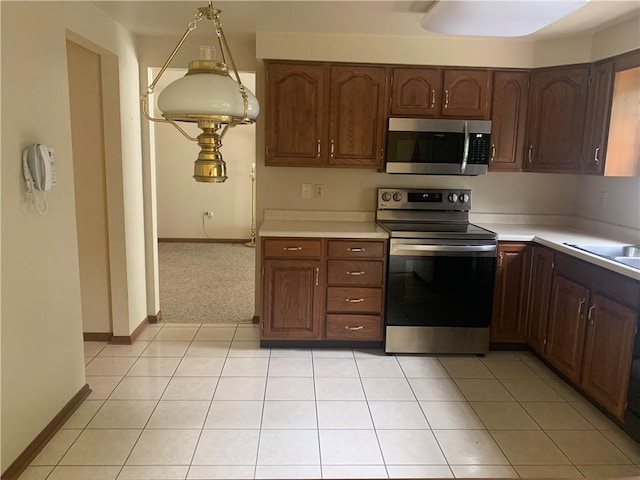 111 Brandywine Dr, Manor, PA 15642 - kitchen with stainless steel appliances, light countertops, and light tile patterned floors