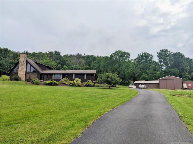350 American Legion Rd, Unity Twp, PA 15650 - view of front facade with a front yard, a chimney, and a forest view