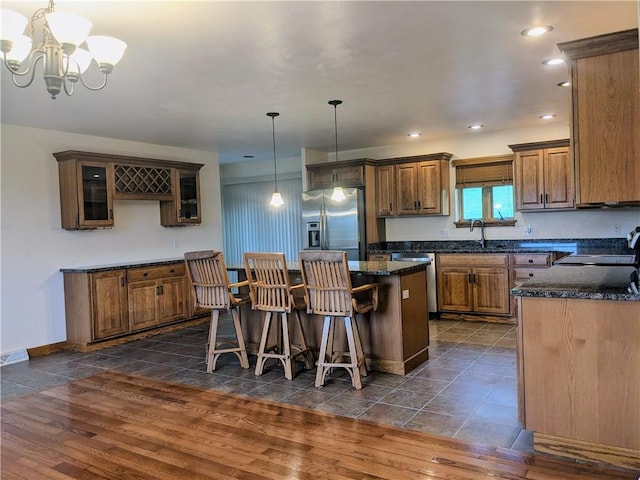 350 American Legion Rd, Unity Twp, PA 15650 - kitchen with stainless steel appliances, a chandelier, a center island, brown cabinets, and recessed lighting