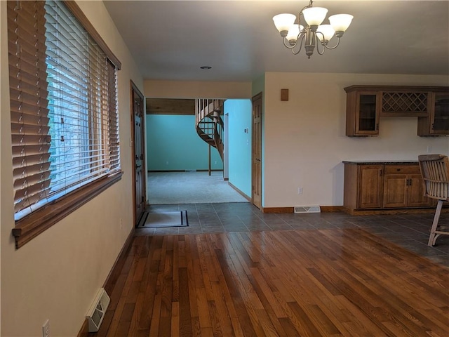 350 American Legion Rd, Unity Twp, PA 15650 - unfurnished dining area featuring stairway, a chandelier, and dark wood-style flooring