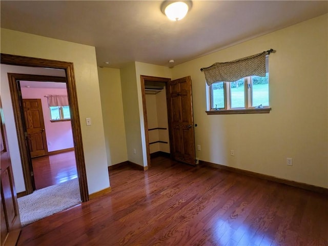 350 American Legion Rd, Unity Twp, PA 15650 - unfurnished bedroom with multiple windows, dark wood-type flooring, and a closet