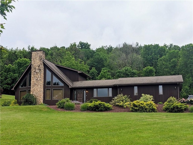 350 American Legion Rd, Unity Twp, PA 15650 - mid-century home with a chimney, a front lawn, and a view of trees