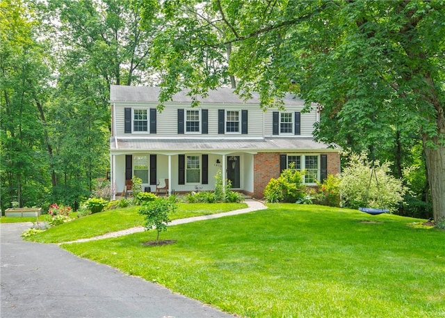 1415 Ashwood Cir, Upper St Clair, PA 15241 - colonial home featuring covered porch, a front lawn, and brick siding