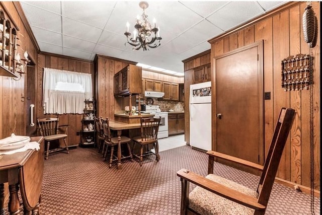 334 E State St, Sharon, PA 16146 - carpeted dining area featuring wood walls and a chandelier