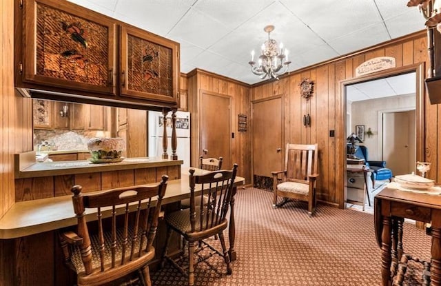 334 E State St, Sharon, PA 16146 - dining room with a chandelier, wooden walls, and carpet flooring