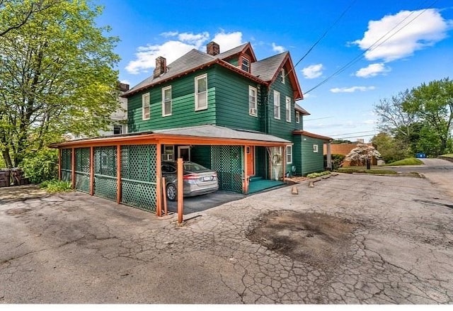 334 E State St, Sharon, PA 16146 - view of property exterior with driveway, a chimney, and a carport