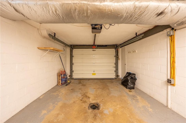 524 Saint Andrews Dr, Hempfield Twp Wml, PA 15601 - garage featuring a garage door opener and concrete block wall