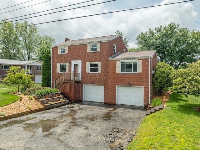 524 Saint Andrews Dr, Hempfield Twp Wml, PA 15601 - colonial inspired home with driveway, an attached garage, a chimney, and brick siding