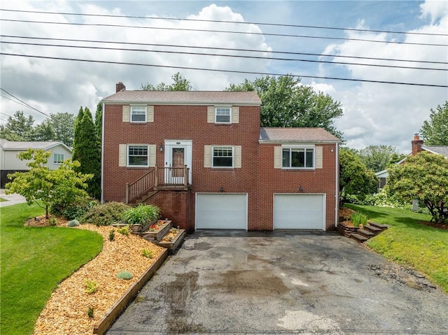 524 Saint Andrews Dr, Hempfield Twp Wml, PA 15601 - colonial home with asphalt driveway, a garage, brick siding, and a front yard