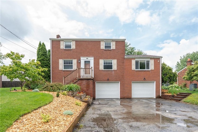 524 Saint Andrews Dr, Hempfield Twp Wml, PA 15601 - colonial home with driveway, a garage, brick siding, a chimney, and a front lawn