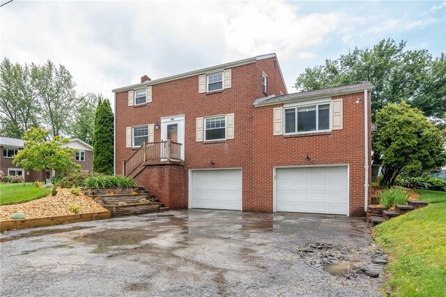524 Saint Andrews Dr, Hempfield Twp Wml, PA 15601 - colonial home with a garage, driveway, brick siding, and a chimney