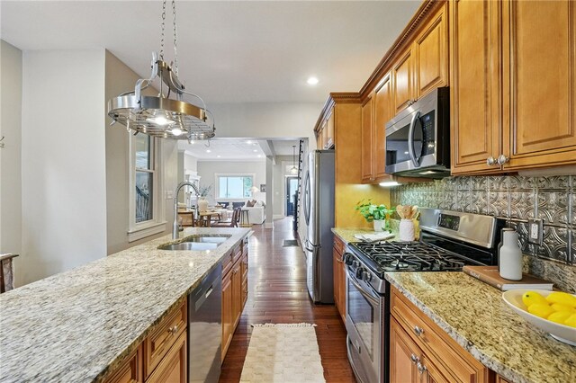 2315 Jane St, South Side, PA 15203 - kitchen featuring stainless steel appliances, dark wood finished floors, brown cabinetry, light stone countertops, and recessed lighting