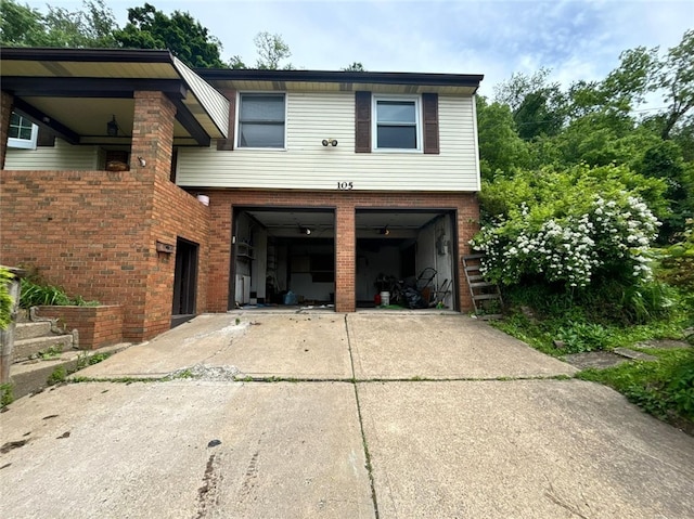 105 Fern Way, Glassport, PA 15045 - view of front of house featuring driveway, an attached garage, and brick siding