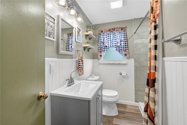 914 E Smithfield St, Elizabeth Twp/Boro, PA 15135 - bathroom featuring a wainscoted wall, vanity, wood finished floors, and a shower with shower curtain