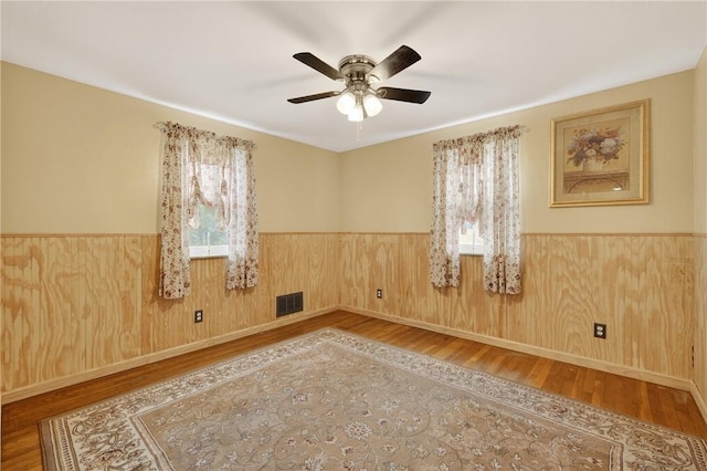 914 E Smithfield St, Elizabeth Twp/Boro, PA 15135 - unfurnished room with plenty of natural light, a wainscoted wall, wood finished floors, a ceiling fan, and wood walls