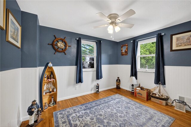 914 E Smithfield St, Elizabeth Twp/Boro, PA 15135 - living area featuring a wainscoted wall, healthy amount of natural light, a ceiling fan, and wood finished floors