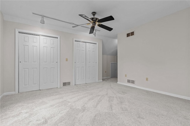 4 Pleasant Grove Dr, Patterson Heights, PA 15010 - unfurnished bedroom featuring multiple closets, carpet flooring, rail lighting, and ceiling fan