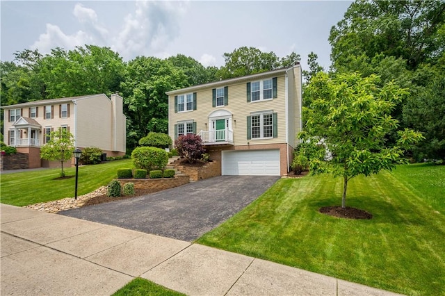 317 Shady Glen Dr, Moon/Crescent Twp, PA 15108 - colonial house with asphalt driveway, a garage, a chimney, a front yard, and brick siding