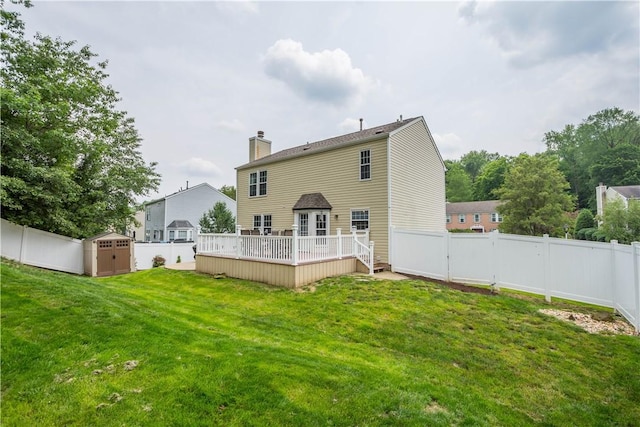 317 Shady Glen Dr, Moon/Crescent Twp, PA 15108 - back of property featuring a storage shed, a deck, a fenced backyard, and a chimney