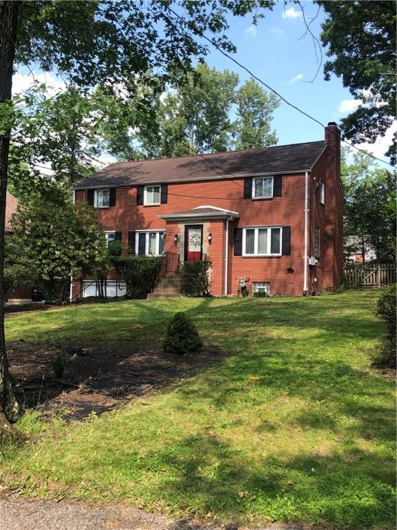 1850 Graham Blvd, Wilkinsburg, PA 15235 - view of front of property featuring a chimney, a front yard, and brick siding