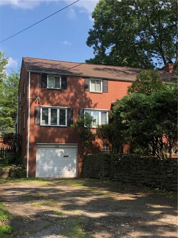 1850 Graham Blvd, Wilkinsburg, PA 15235 - colonial inspired home featuring driveway, an attached garage, and brick siding