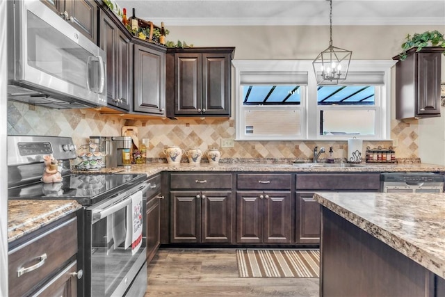 201 Millstream Ln, Zelienople Boro, PA 16063 - kitchen with stainless steel appliances, a chandelier, light wood-style floors, dark brown cabinets, and light stone counters